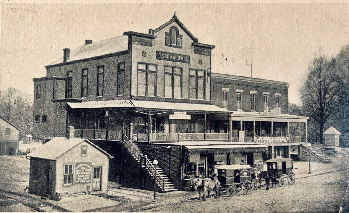 Takoma Hall in Takoma Park, DC, with horse-drawn carriages outside.